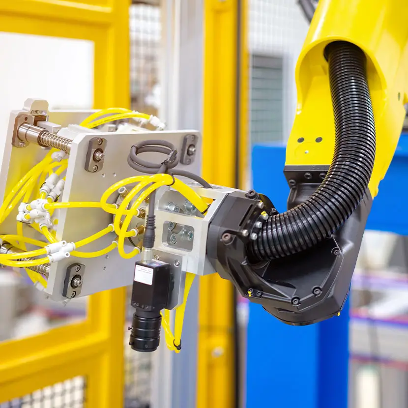 Robotic arm with attached sensors and wiring for automated factory operations