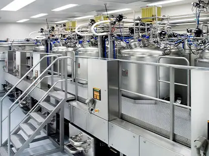 Interior view of processing facility with multiple tanks and piping systems